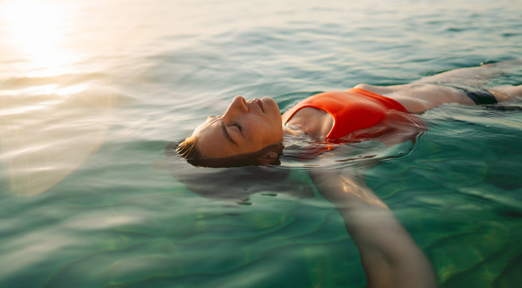 Mid adult woman swimming in the calm sea water